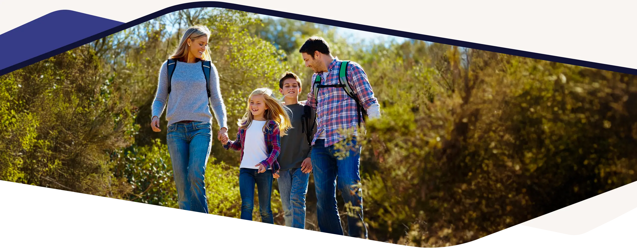 Chiropractic Gresham OR Family Walking in Woods Happy family on a hike in sunny day